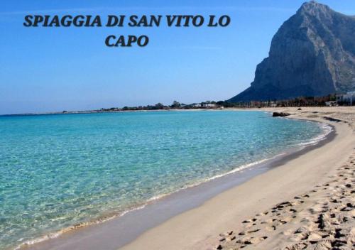 a view of a beach with a mountain in the background at Il Girasole in Paceco