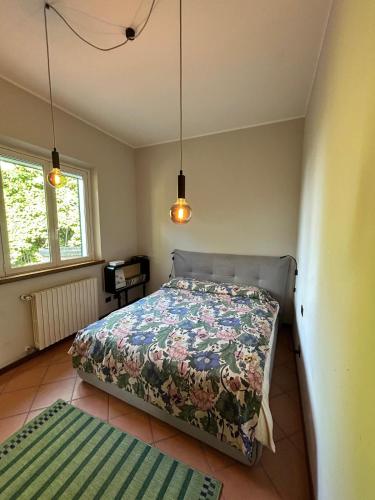 a bedroom with a bed and two rugs in it at La Bucolica in Murata