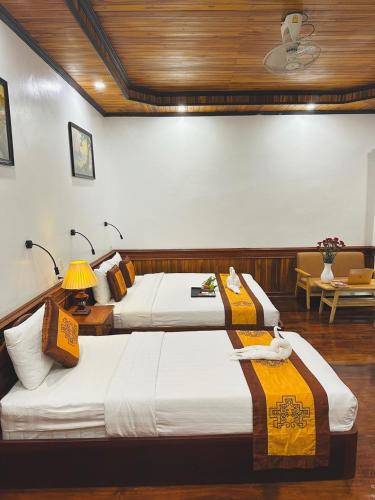Katil atau katil-katil dalam bilik di Oudomlith Villa Luang Prabang