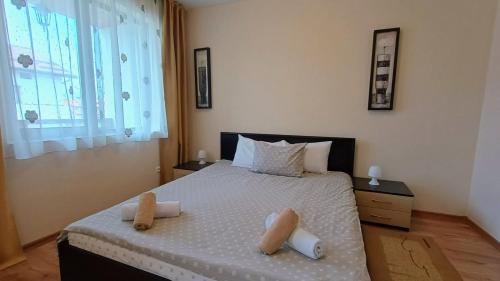 a bedroom with a bed with two towels on it at Prime Apartments in Bansko