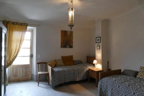 a living room with a bed and a couch at 17th CENTURY HOUSE with terrace, near to Castle in Capendu