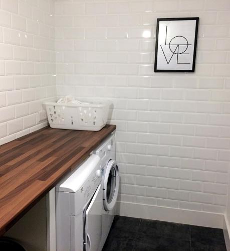 a laundry room with a washer and dryer at Luxury Loft Apartment with Stunning Roof Garden in Killorglin
