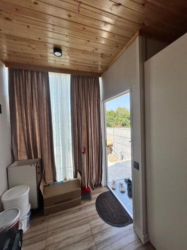 a living room with a large window and a door at Nohurgöl villa in Gabala
