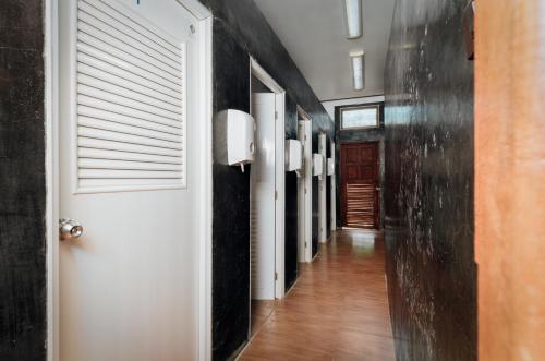 a hallway with black walls and a white door at Ibiza House Phi Phi in Phi Phi Don