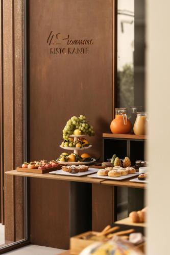 a table with different types of food on it at Hotel Tannure in San Vito lo Capo