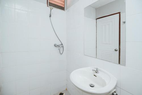 a white bathroom with a sink and a mirror at Ibiza House Phi Phi in Phi Phi Don
