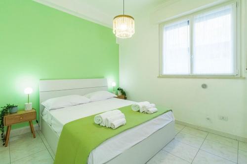 a white bedroom with a bed with towels on it at Casa Violante in Ancona
