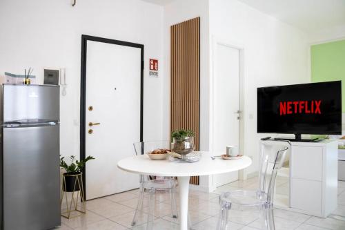 a kitchen with a white table with a tv on it at Casa Violante in Ancona