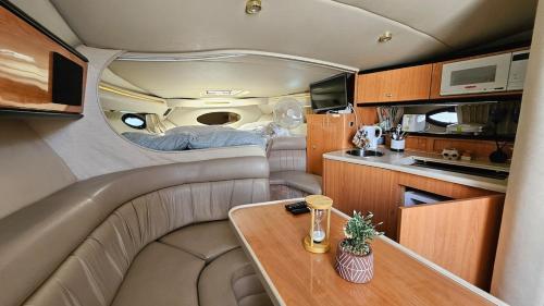 a small room with a table and a kitchen at Lisbon Boat Speedboat O Thor in Lisbon