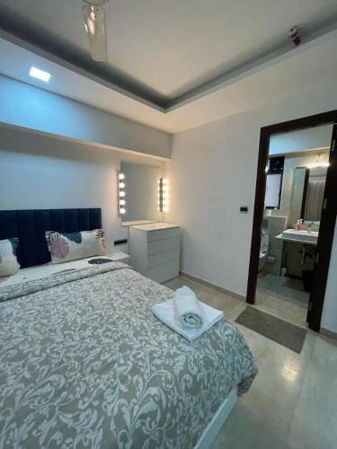 a bedroom with a bed with a sink and a mirror at Business-Ready Apt near Jio World Centre 1BR Gym Pool WiFi in Mumbai