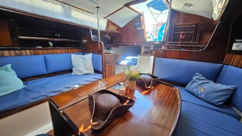 a dining room with a table and a blue couch at Lisbon Boat Puma 34 in Lisbon