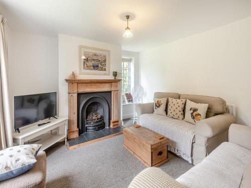 a living room with a couch and a fireplace at Peaceful Farmhouse - Uk44787 in Grainthorpe