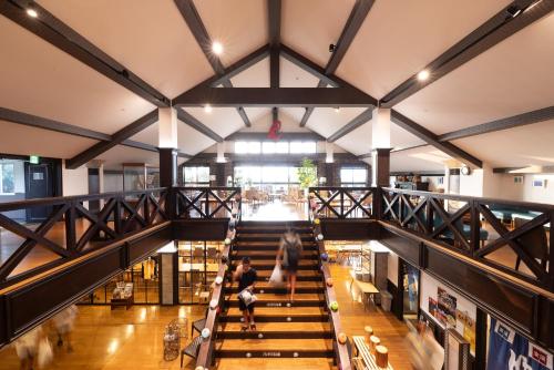 an overhead view of a library with people walking down the stairs at Grampus Inn Shirahama in Shirahama