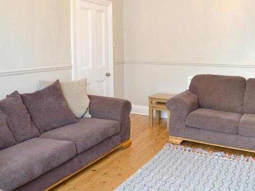 a living room with a couch and a chair at Middleton House in Filey