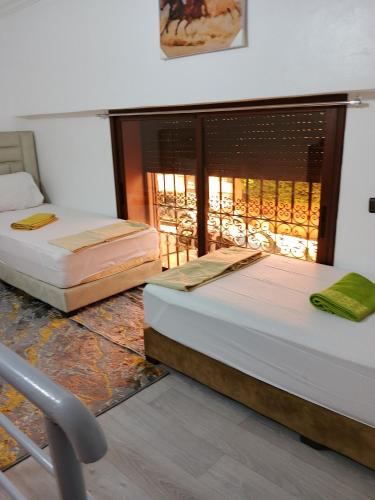 Ένα ή περισσότερα κρεβάτια σε δωμάτιο στο Le Palmier de Guéliz