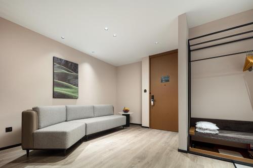 a living room with a couch and a table at Atour Hotel Foshan Chancheng Zhangcha in Foshan