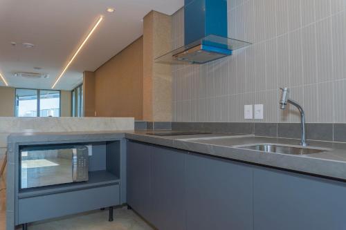 a kitchen with a sink and a counter top at Vista mar - Flat Parque do Cais 1211 in Recife