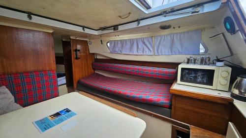 a small tv sitting in the back of an rv at Lisbon Classic Boat 25 Belém in Lisbon