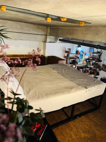 a bed in a room next to at Lofty Hipster in Johannesburg