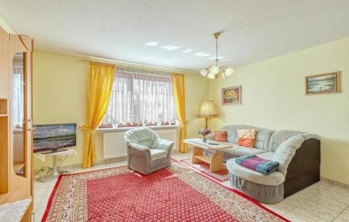 a living room with a couch and a tv at Ferienwohnung Wesenberg in Strasen