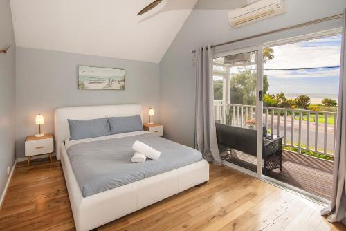 a bedroom with a bed and a balcony at Beachside Retreat, WIFI, Kayaks, AC to all rooms in Dunsborough