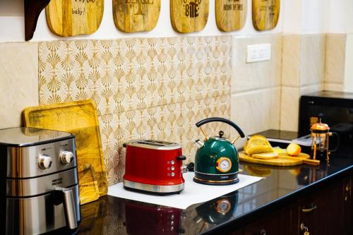 a kitchen with a tea kettle on a counter at Aurora Luxe Residence in Jaipur