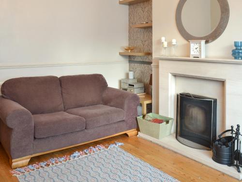 a living room with a couch and a fireplace at Middleton House in Filey