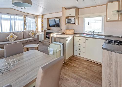 a kitchen and living room of a caravan at Stanwix Park in Silloth