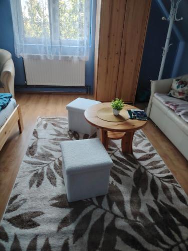 a living room with a table and a couch at Silye Vendégház in Hortobágy