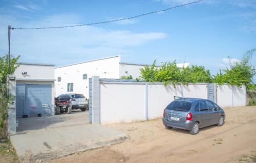 a car parked in a parking lot next to a garage at Elysee in Mbour