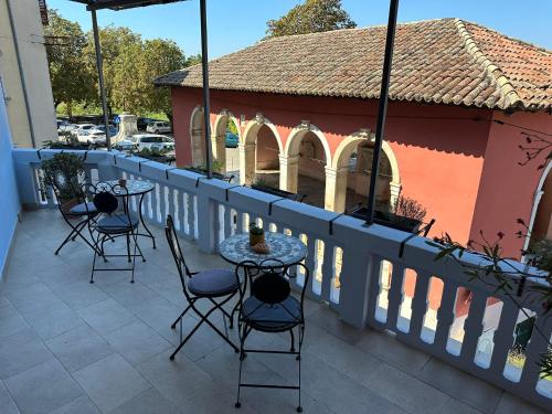 a patio with chairs and tables and a building at B&B Mila in Oprtalj
