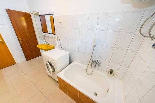 a bathroom with a toilet and a sink and a tub at Apartments Borik in Zadar