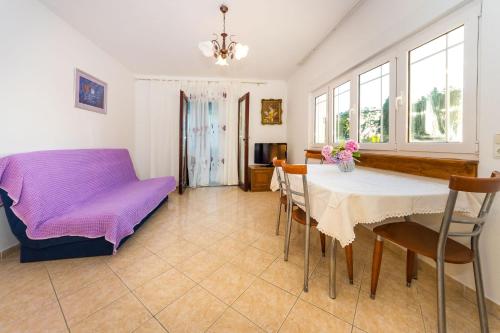 a dining room with a table and chairs at Apartments Borik in Zadar
