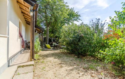 a path next to a house with trees and bushes at Gorgeous Home In Dego With Wifi in Dego