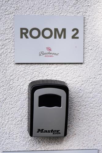 a sign that reads room with a black and white button at Beechwood in Oban