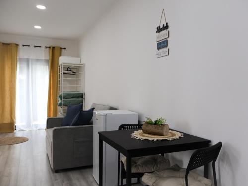 a living room with a table and a couch at Souto 25 - T0 na Régua in Peso da Régua