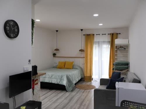 a small bedroom with a bed and a couch at Souto 25 - T0 na Régua in Peso da Régua
