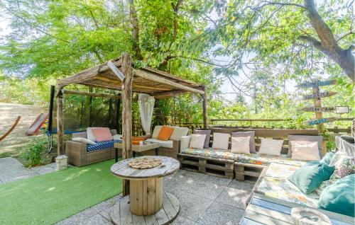 a outdoor seating area with a gazebo and a table at Gorgeous Home In Dego With Wifi in Dego