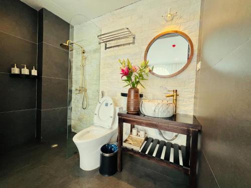 a bathroom with a toilet and a mirror at Sapa Villa Florence in Sa Pa