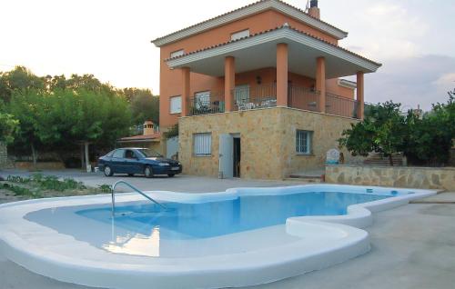 a house with a swimming pool in front of a building at Amazing Home In Xàtiva in Xàtiva