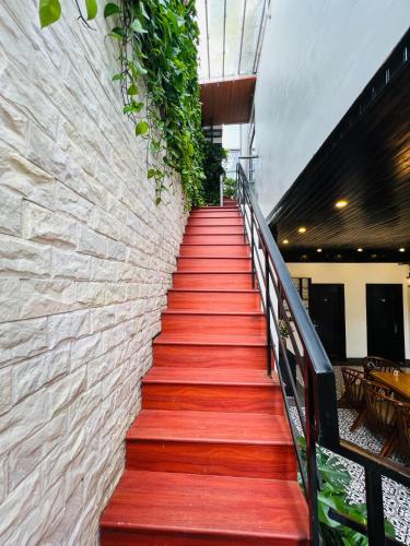 a stairway with red carpeting and a brick wall at Sapa Villa Florence in Sa Pa