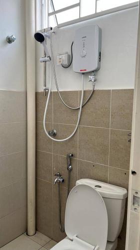 a small bathroom with a toilet and a shower at MITC Comfort Stay in Malacca