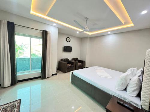 a bedroom with a bed and a living room at Sweet Villa Guest House Islamabad in Islamabad