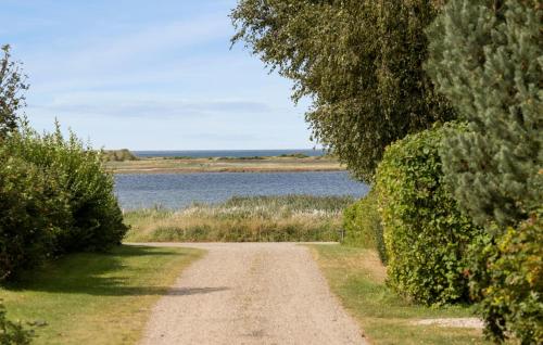 a dirt road next to a body of water at Amazing Home In Føllenslev With Wifi in Føllenslev