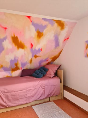 a bedroom with a bed with a painting on the wall at Schönes Haus in Tüttendorf