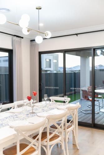 a white dining room with a table and chairs at Haven Lakeside Berwick in Berwick