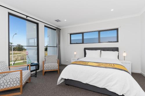 a bedroom with a bed and a large window at Haven Lakeside Berwick in Berwick