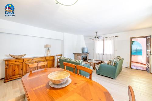 a living room with a wooden table and chairs at Apartamentos Ibiza Casa Azahar in Alcossebre