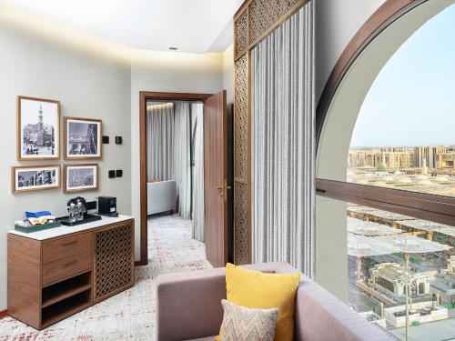 a living room with a window and a couch at Elaf Taiba Hotel in Al Madinah