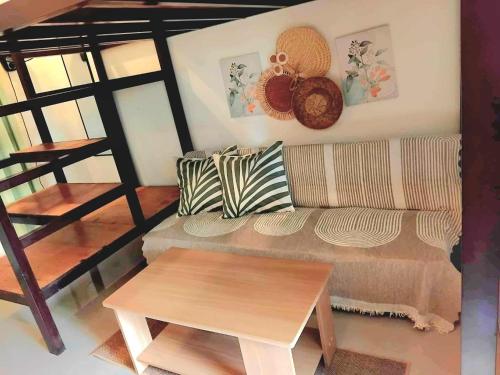 a living room with a couch and a table at Siargao Alcove Verde Eco-Sanctuary Hostel in General Luna